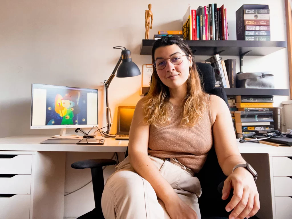 Illustrator and Designer Mariana Ponte seating at her desk